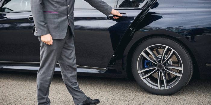 Cropped,Photo,Of,A,Driver,In,A,Stylish,Suit,Opening