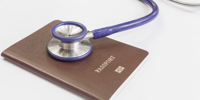 Close,Up,Stethoscope,And,Passport,On,White,Background